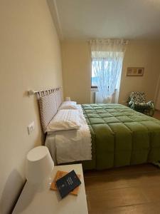 1 dormitorio con 1 cama y 1 libro sobre una mesa en Casa Vacanze Nonno Giò, en Sulmona