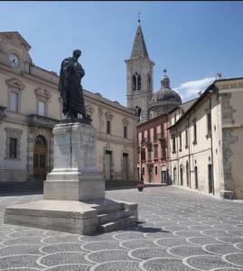 a statue of a man standing in a courtyard at Casa Vacanze Nonno Giò in Sulmona