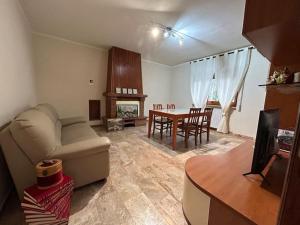 a living room with a couch and a table at Casa Vacanze Nonno Giò in Sulmona