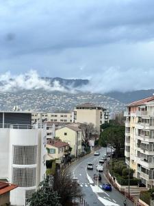 a city street with buildings and cars on the road at Cosy Appartement in Cannes