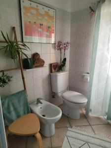 a bathroom with a toilet and a sink at Casa An'anasha in Luino +21 photos