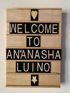 a wooden sign with the words welcome to amazonasiauadoruador at Casa An'anasha in Luino