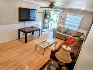 a living room with a couch and a flat screen tv at Glenwood Haus in Wichita Falls