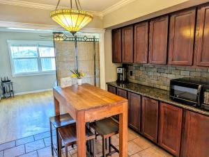 a kitchen with a wooden table and a microwave at Glenwood Haus in Wichita Falls