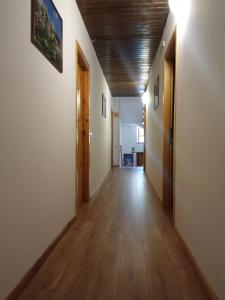 an empty hallway with wooden floors and doors at Stella Alpina Fabrezza in Saviore dellʼAdamello