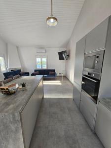 a kitchen and living room with a counter top at Villa Sakrakis seaview villa in Stavros