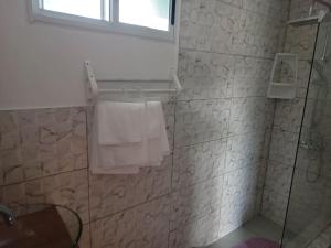 a bathroom with a shower and a sink and towels at Casa 2 pisos Para 5 personas toda equipada in Colonia del Sacramento