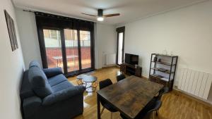 a living room with a couch and a table at El chabisque de Ner in Villamediana de Iregua