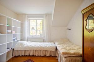 a small bedroom with a bed and a window at Outstanding apartment close to Gothenburg in Kungälv