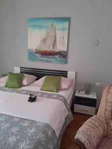 a bedroom with two beds and a painting of a ship at Apartment Šime Bibinje in Bibinje