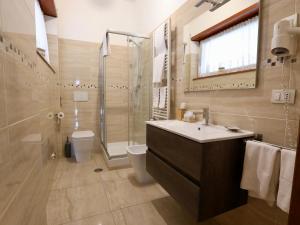 a bathroom with a sink and a shower and a toilet at Villa Gisi Guest House in Fiumicino
