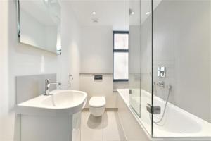 a white bathroom with a sink and a toilet at Comfy 2 Bedrooms by Natural History Museum in London