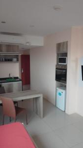 a kitchen with a table and a stove and refrigerator at Audencia del Mar in La Paloma