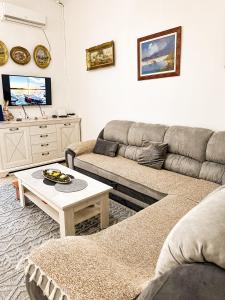 a living room with a couch and a coffee table at Venera Apartman in Škaljari
