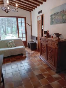 a bedroom with a bed and a table in a room at La maison du rouquet in Le Beausset