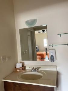 a bathroom with a sink and a mirror at Hotel las Palmas in Hermosillo