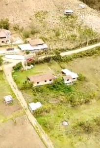 an aerial view of a farm with buildings and grass at Hospedaje Leonor in Cuenca