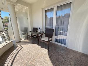 a balcony with a table and chairs and a window at Villa Dislievski in Ohrid