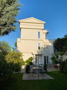 a building with a table and chairs in front of it at Villa 35 in Tirana +51 photos