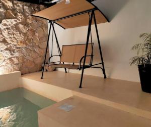 a swing in a room with a pool of water at Casa Colibri Central Villa with Private Pool and Tub Merida in Mérida