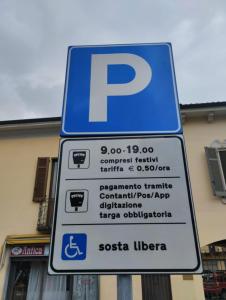 un cartello di parcheggio su un palo di fronte a un edificio di Casa Vigevanese CIR 018177-LNI-00019 a Vigevano