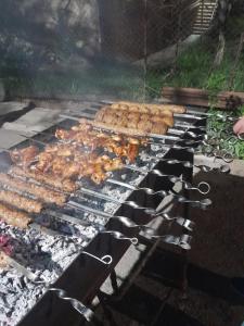 a grill with chickens and other food on it at Mark B&B in Yeghegnadzor