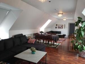 a living room with a couch and a table at Villa Signedal Hostel in Kvidinge