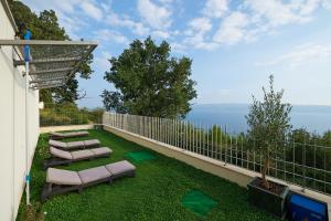 a balcony with chairs and a view of the water at Villa Maranata-5 stars-pool-spa-gym-free parking-privacy in Jesenice