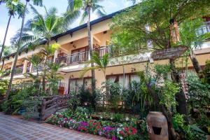 a building with a lot of flowers in front of it at Bao Quynh Bungalow in Mui Ne