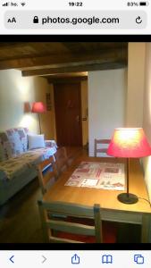 a living room with a table with a lamp on it at Casa vacanze romantica in San Giacomo