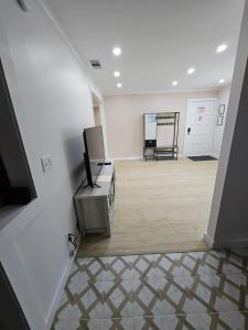 a large room with a white wall and a tv at Peaceful Relaxation and Comfort in Hilton Head Island