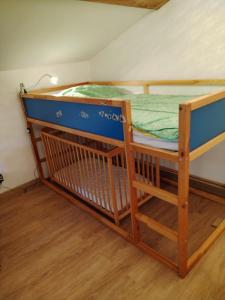 a bunk bed in a room with a wooden floor at Maison de Fernand in Montjay
