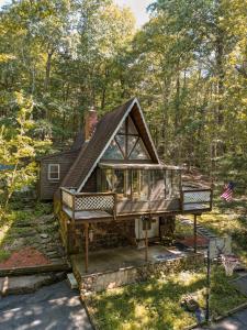 a house in the woods with a roof at Escape in our Rain-Forest A-Frame Cabin-Retreat 1hour from The Pononos in Harveys Lake