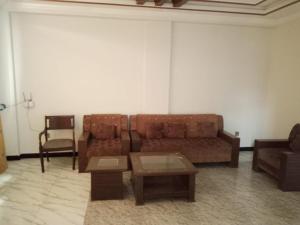 a living room with a couch and a table at Murree Apartments in Murree