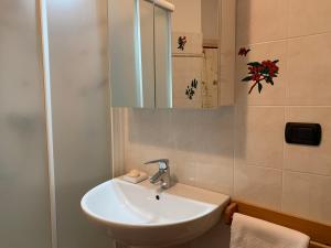 a bathroom with a white sink and a mirror at VECCHIA STAZIONE - by Satisfactual Property in Menaggio +18 photos