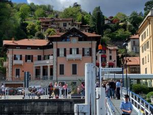 a group of people on a bridge over a river at VECCHIA STAZIONE - by Satisfactual Property in Menaggio