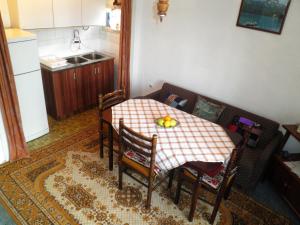 a kitchen with a table and a couch and a table and chairs at Central Rustic House in Žabljak