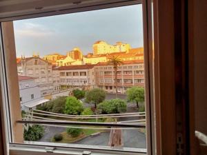 a view of a city from a window at Acogedor y luminoso eco-estudio en Gijón in Gijón