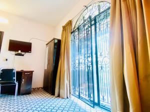 a room with a large glass door with curtains at Separate 2 AC Rooms Kalyani Nagar Near Pune Airport Osho Garden WTC in Pune