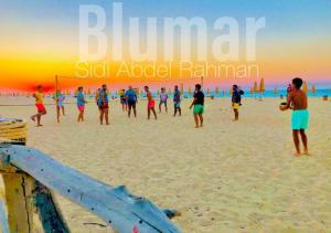 a group of people playing soccer on the beach at Blumar Sidi Abdel Rahman 2 bedrooms Chalet North Coast in El Alamein