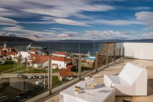 a balcony with a table and a view of a city at Original House Hotel Boutique in Ushuaia
