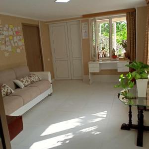 a large living room with a couch and a sink at Hostel FORREST in Kutaisi