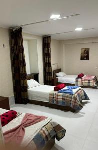 a hotel room with two beds in a room at Hostel FORREST in Kutaisi