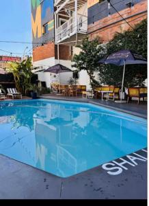 a large blue swimming pool in front of a building at Studio bliss @maboneng in Johannesburg