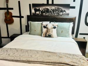 a bed with a picture of a cow on it at Studio bliss @maboneng in Johannesburg
