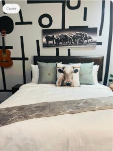 a cow head on a bed in a bedroom at Studio bliss @maboneng in Johannesburg
