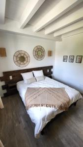 a bedroom with a large bed with white sheets at Villa Delta Spa in Munchhausen