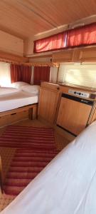 a small room with two beds in an rv at Каравана Мая in Chernomorets