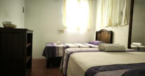 Giường trong phòng chung tại Casa Bugambilias