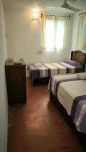 Ein Bett oder Betten in einem Zimmer der Unterkunft Casa Bugambilias